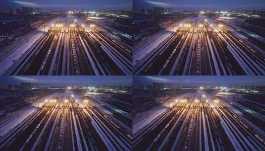 中国哈尔滨南站冬季货运火车夜景航拍高清在线视频素材下载