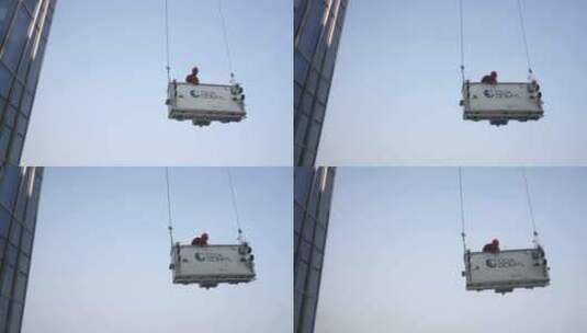 工程师在摩天大楼吊篮上工作高清在线视频素材下载