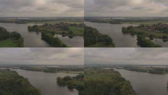 无人机拍摄的湖泊，河岸上有村庄和美丽的风景高清在线视频素材下载