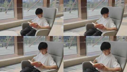 中国小男孩在图书馆大厅看书阅读高清在线视频素材下载