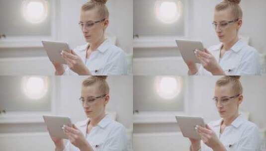 女医生在诊所里使用平板电脑高清在线视频素材下载