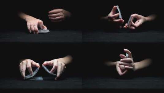 从黑暗中伸出一双玩纸牌的手高清在线视频素材下载