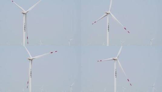 航拍蓝天下风力发电场高清在线视频素材下载