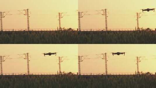 4K拍摄夕阳下飞在稻田上空的无人机高清在线视频素材下载