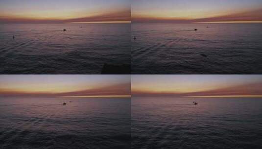 日落时海洋中的两艘剪影船。空中。高清在线视频素材下载
