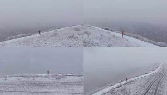 航拍男子走在新疆禾木村的风雪中高清在线视频素材下载