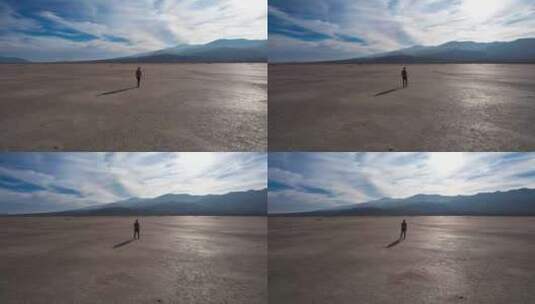 男人站在干涸的湖面上高清在线视频素材下载