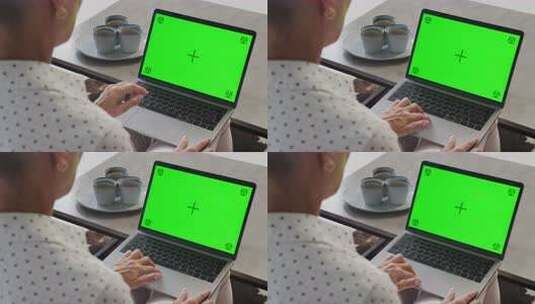 在家使用带绿屏笔记本电脑的人高清在线视频素材下载