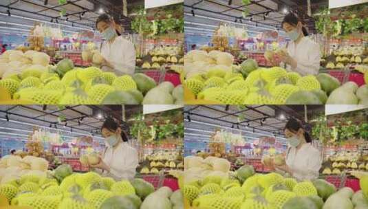 戴口罩的青年女人在超市选购水果高清在线视频素材下载