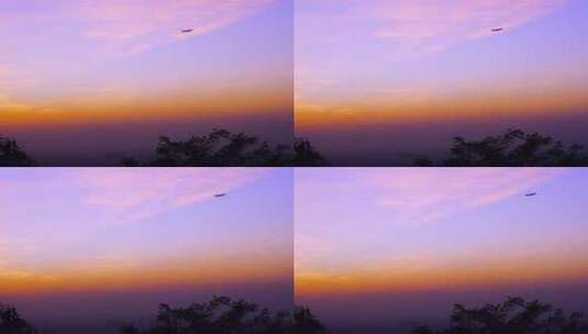 飞机飞过唯美的夕阳晚霞天空高清在线视频素材下载