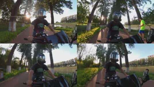 夕阳落日夏天男子骑摩托车在林荫大道高清在线视频素材下载
