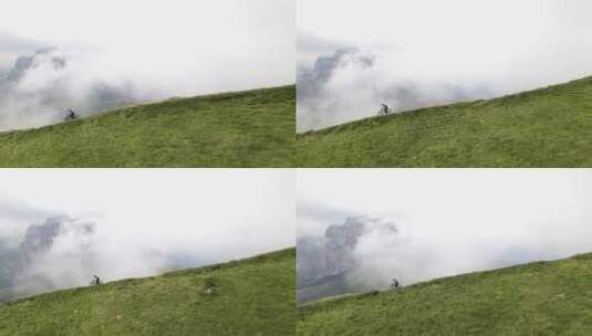 航拍在山间云雾中骑行高清在线视频素材下载