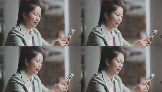 女性在办公室内使用手机高清在线视频素材下载