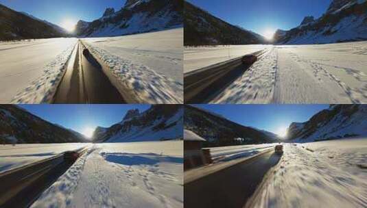 FPV无人机航拍冬日汽车行驶在雪地中的公路高清在线视频素材下载