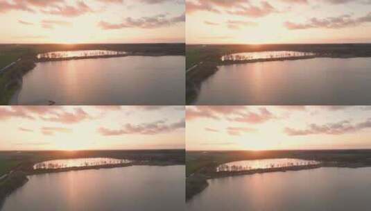 航拍日落时分波光粼粼的湖面森林夕阳高清在线视频素材下载