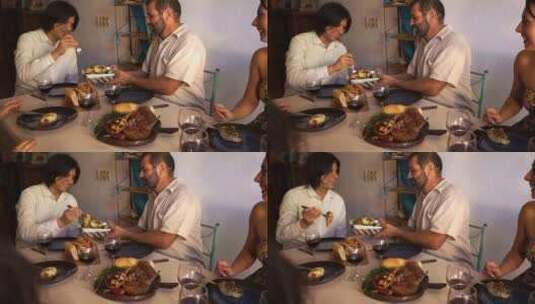一个在餐桌上提供墨西哥卷饼的男人高清在线视频素材下载