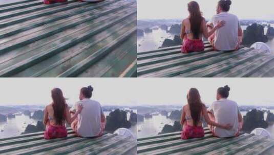 夫妇坐在屋顶上欣赏山川高清在线视频素材下载