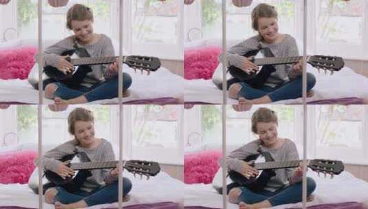 女孩在床上弹吉他高清在线视频素材下载