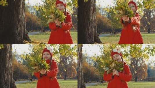 女孩抱着一束秋天的叶子高清在线视频素材下载
