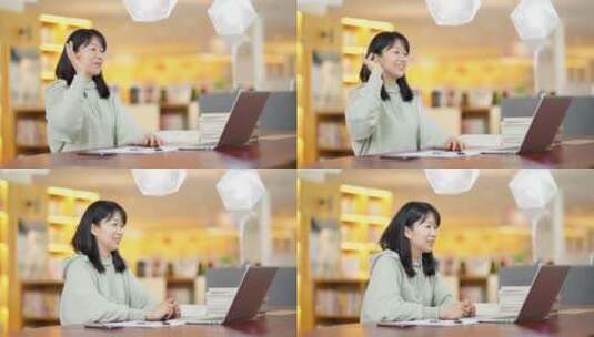 年轻女子在图书馆使用笔记本电脑上网视频高清在线视频素材下载