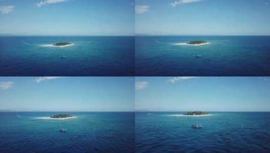 无人机射击，从远处飞向斐济以南海岛为背景的一艘船高清在线视频素材下载