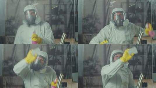 一个穿着呼吸器和白色防护服的男人在擦窗户高清在线视频素材下载
