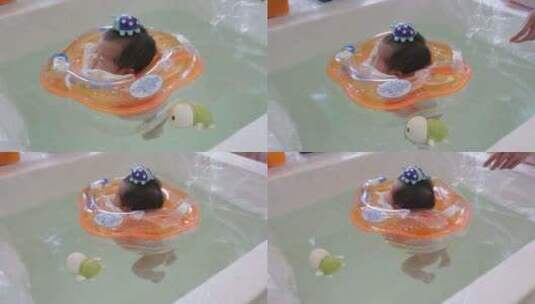 中国新生儿亚洲小孩宝宝在教练帮助下游泳高清在线视频素材下载