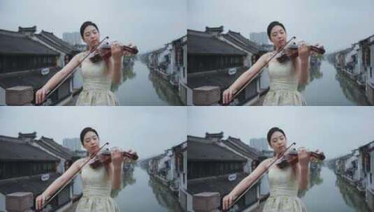 美女在水乡南长街拉小提琴高清在线视频素材下载