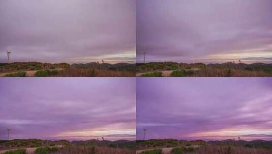 风力涡轮机在黎明时分在紫色天空下的丘陵地高清在线视频素材下载