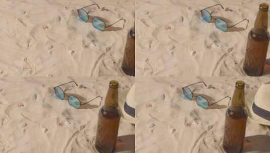 沙堆里的眼镜和瓶子高清在线视频素材下载