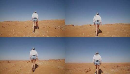 行走在沙漠中的女人高清在线视频素材下载