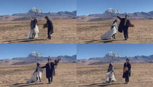 高原枯黄草原雪山情侣跳舞拍写真婚纱高清在线视频素材下载