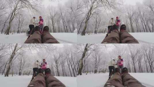 父母拉着坐在雪橇上的女儿高清在线视频素材下载