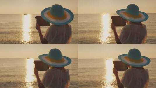 戴帽子的女人正在拍摄海上美丽的黎明 高清在线视频素材下载