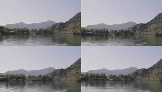 乘坐传统船只在达拉曼溪上的石头山谷中巡航高清在线视频素材下载