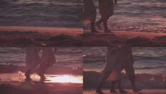 夕阳中情侣手牵手在海边散步高清在线视频素材下载