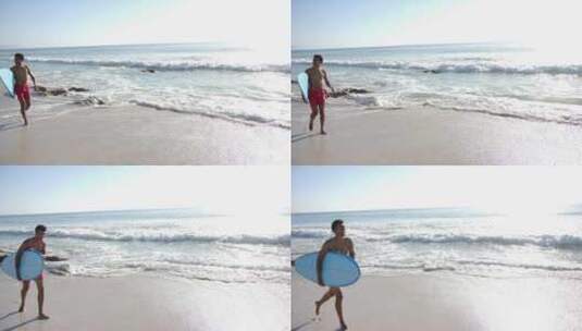 一个年轻的混血儿拿着冲浪板沿着海岸走，还高清在线视频素材下载