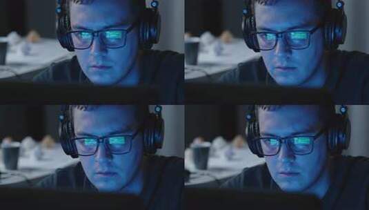 男人戴耳机专注看电脑画面高清在线视频素材下载