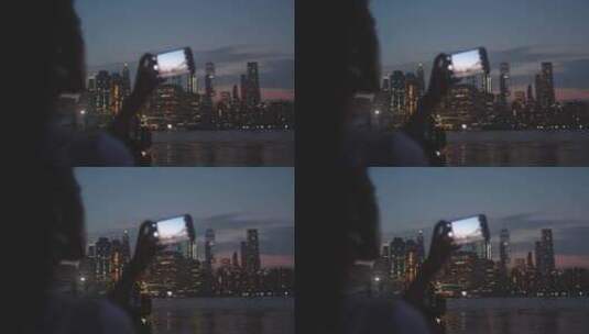 女人用智能手机拍摄夜景高清在线视频素材下载