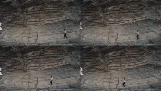 女人在陡峭的岩石上行走高清在线视频素材下载