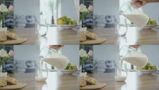 把牛奶倒进桌子上的玻璃杯里高清在线视频素材下载