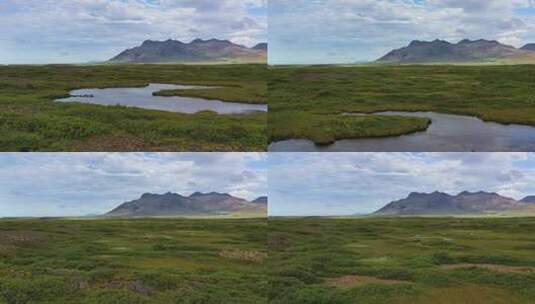 冰岛。山、田野和河流的鸟瞰图。冰岛白天的风景。高清在线视频素材下载