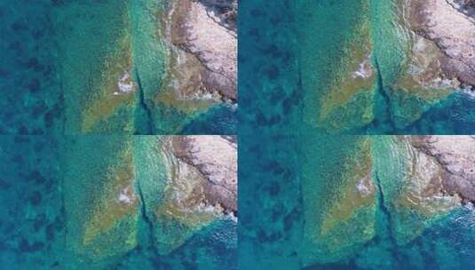 蓝色海洋边的多石海岸高清在线视频素材下载