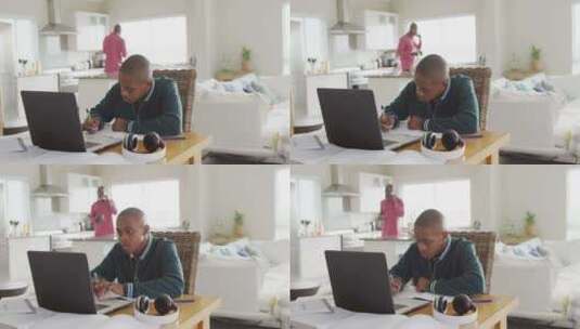 专注的非裔美国男孩带着笔记本电脑在家上在线课程的视频高清在线视频素材下载