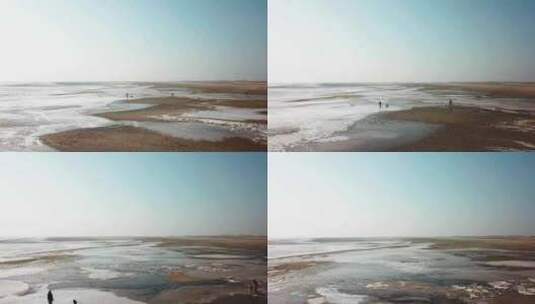 岸上的人们走在冰冻的水面上高清在线视频素材下载