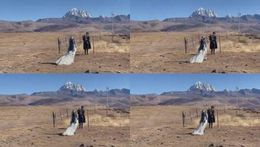 高原枯黄草原雪山情侣走向雪山拍写真婚纱高清在线视频素材下载