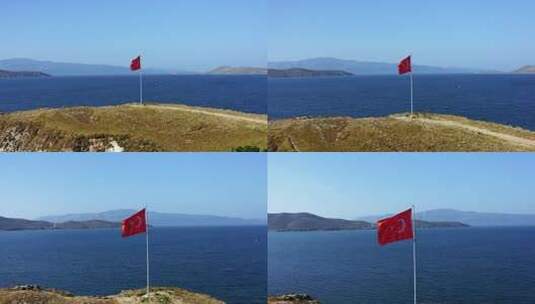 无人机拍摄的土耳其国旗在海边随风飘扬。这片土地被小灌木丛覆盖。高清在线视频素材下载