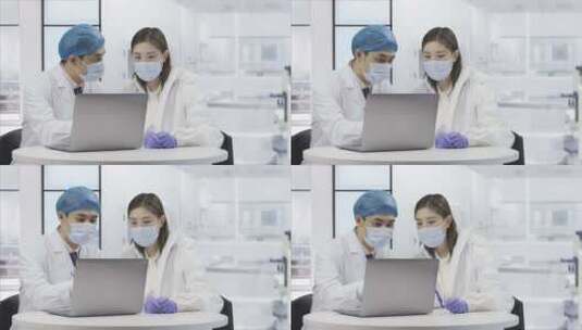 两位身穿白大褂的医疗科研人员在电脑前交谈高清在线视频素材下载