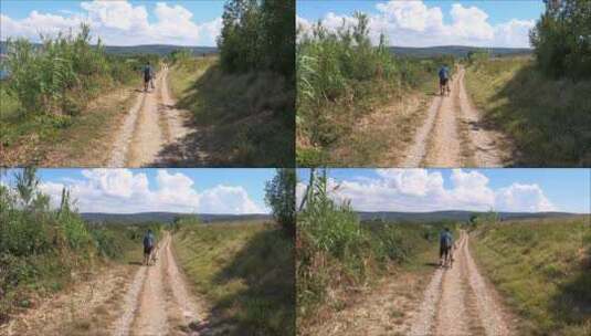 在山间小路上推着自行车的男人高清在线视频素材下载