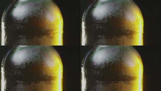一瓶慢慢旋转的玻璃瓶上凝结的水滴向下流动高清在线视频素材下载